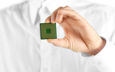 Man holding microprocessor in his hand on white background