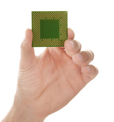 Male hand holding microprocessor on white background