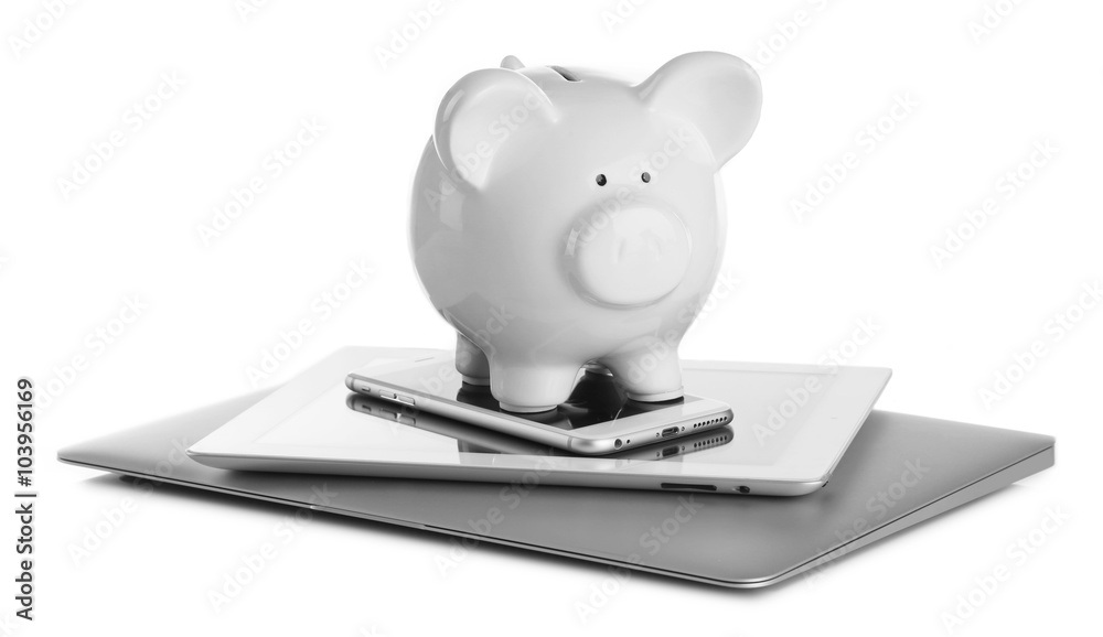 Wall mural Piggy bank on modern devices isolated on white