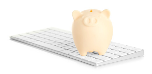 Piggy bank on computer keyboard isolated on white