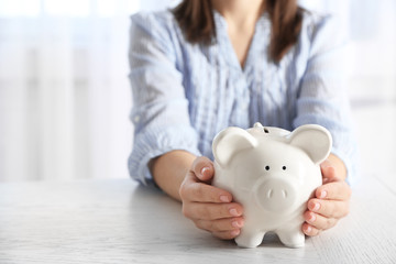 Woman holding piggy bank closeup