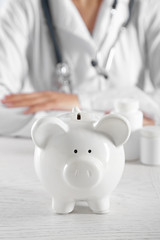 Doctor hands with piggy bank closeup