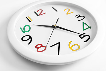 Round wall clock with colorful figures, close up