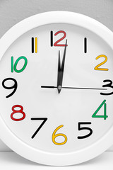 Round wall clock with colorful figures, close up