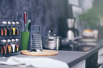 Modern kitchen table with grater, cutting board and spices