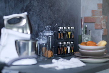 Fototapeta na wymiar Mixer, utensils and spices on modern kitchen table