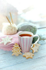 Beautiful winter composition on windowsill with cup of hot drink