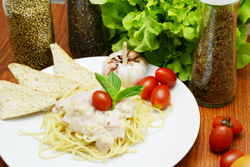 spaghetti white cream sauce and basil leafe
