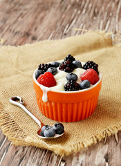 oatmeal with berries on a wooden table, selective focus