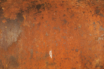 Red rust on the old and weathered metal door