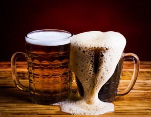 Drink. two glasses beer red background