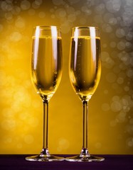 Drink. two glasses champagne yellow background