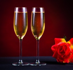Drink. two glasses champagne red background rose