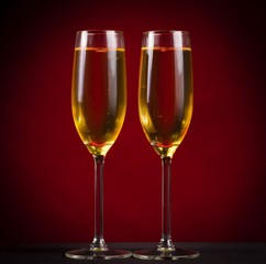 Drink. two glasses champagne red background!