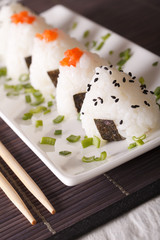 onigiri rice balls with salmon and sesame close-up. Vertical

