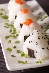 Japanese food onigiri rice balls close-up on a plate. vertical
