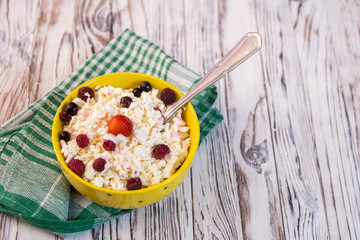 cottage cheese with fruit on a wooden table