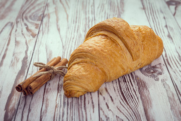 Tasty croissants on brown wooden background