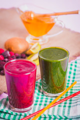 glasses of various smoothies with straws for healthy dieting breakfast