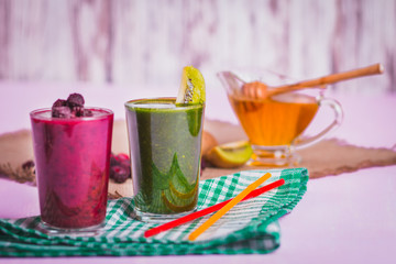glasses of various smoothies with straws for healthy dieting breakfast