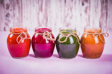 Jars of tasty jam on wooden background
