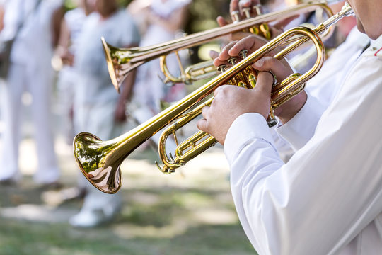 military musicians playing on trumpets in army brass band