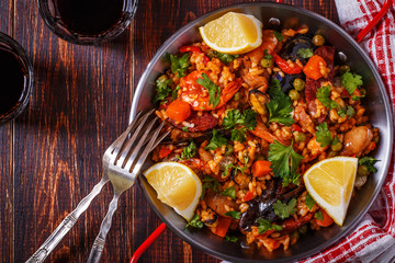 Paella with chicken, chorizo, seafood, vegetables and saffron se