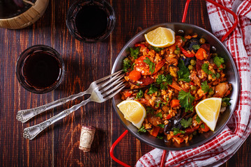 Paella with chicken, chorizo, seafood, vegetables and saffron se