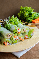 spring rolls with fresh vegetable on wooden table