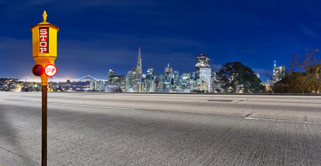 traffic light on asphalt road with cityscape of San Francisco
