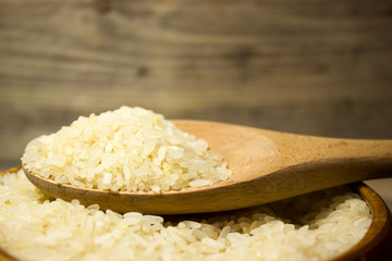 Grains of rice in wooden plate