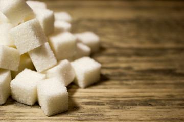Sugar cubes on wooden background