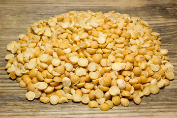 Crushed dried peas on wooden background