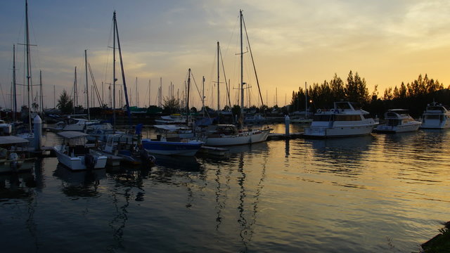 Timelapse of Beautiful composition view of Malaysian Harbour with a yatch during sunset.Vibrance colour.