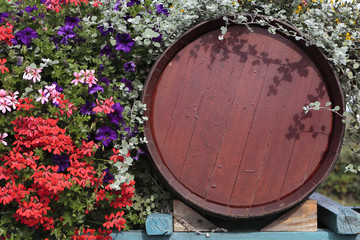 France beaujolais burgundy wood red wine barrel with flower display in floral vineyard village at...