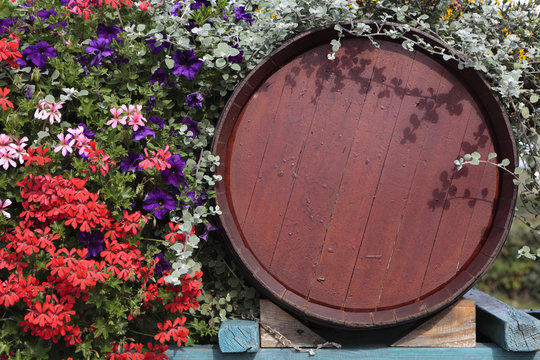 France beaujolais burgundy wood red wine barrel with flower display in floral vineyard village at grape harvest time photo