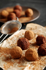 Sweet chocolate truffle on a black wooden table