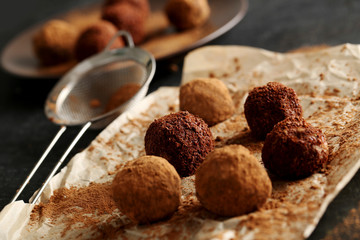 Sweet chocolate truffle on a black wooden table