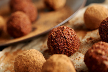 Sweet chocolate truffle on a black wooden table