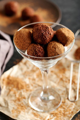 Sweet chocolate truffle on a black wooden table