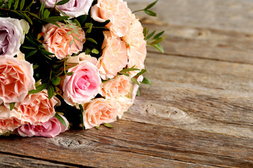 Bouquet of beautiful roses on a grey wooden table
