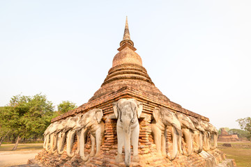 An ancient laterite/sandstone pagoda in Sukhothai's UNESCO world heritage historical park with elephant sculptures all around the four sides. The place is public property, no release document required