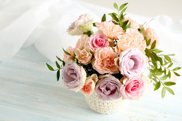 Bouquet of beautiful roses on a blue wooden table