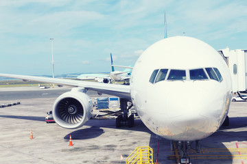 white airplane in apron in cloudy sky