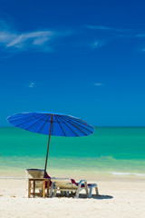 Fototapeta na wymiar lounge chairs with sun umbrella on a beach
