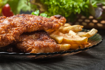 Fried fish in crispy batter with chips