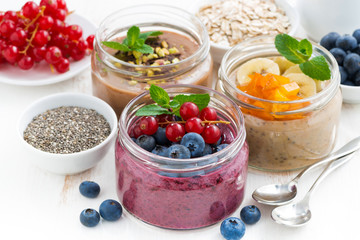 assorted breakfast of chia seeds and fruits in jars 