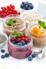 assorted breakfast of chia seeds and fruits in jars 