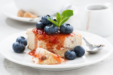 piece of cheesecake with berry jam on plate