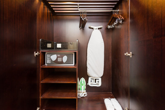 Cabinet with ironing board and security safe